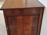 a small wooden cabinet in the corner of a room