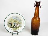 a bottle and a plate sitting next to each other on a table