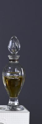 a bottle of perfume sitting on top of a box