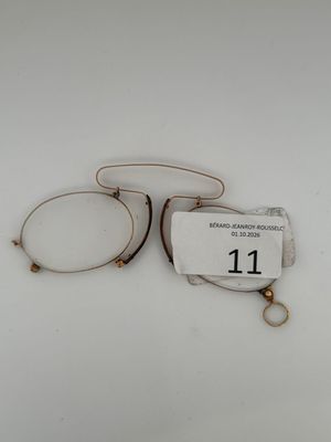pair of eyeglasses with tags on them on a white surface