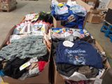 two boxes of clothing sitting on the floor in a warehouse