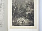 an open book with a picture of a man sitting on a bench in the woods