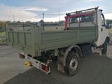a green truck that is parked on the side of the road