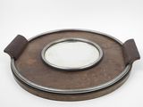 a small round mirror sitting on top of a wooden plate