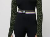 a woman in a black top and green leopard print top