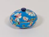 a small blue box with a floral design on it