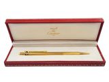 a gold pen in a red box with a white background