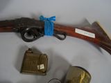 a rifle with a blue ribbon on it next to other items