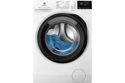 a washing machine with a blue cloth in front of it