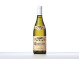 a bottle of white wine sitting on top of a table