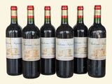 six bottles of red wine lined up in a row on a table