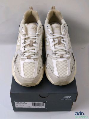 a pair of new balance shoes in a box
