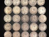 a group of twenty different british coins on a black background