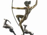 bronze statue of a woman with a bow and deer on a base