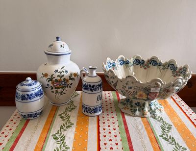 a table with a bowl, vases, and salt shakers on it
