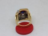 a gold ring with a blue stone in it