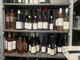 many bottles of wine on the shelves in the store