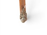 a small wooden table with a cat head on top of it
