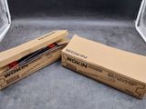 two boxes of brown paper sitting next to each other on a floor