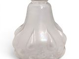 a glass vase that is sitting on a white surface