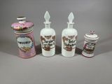 several different types of perfume bottles and containers sitting on a table