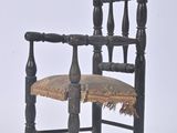 a black chair with a brown seat and a brown cushion