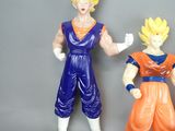 two figurines of gohan and vegeta are posed next to each other