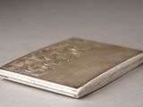 a small silver cigarette case sitting on a table