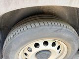 a tire on the side of a car with a hole in the tire