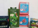 three boxes of games and a clock on a table