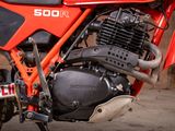 a close up of a red motorcycle parked in a garage
