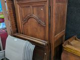 a chair that is sitting in front of a cabinet