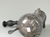 pair of silver teapots with handles and handles on a white surface