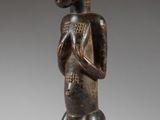 a wooden statue of a man with a hat on his head