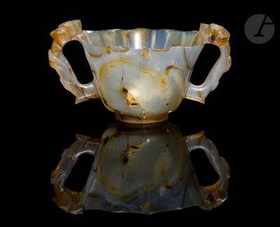 a picture of a glass cup with a handle on a reflective surface