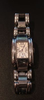 a watch that is sitting on a black surface