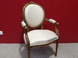 a white chair sitting in front of a red wall