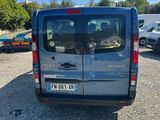 the back of a silver van parked in a parking lot