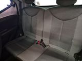 a seat in the back of a car with a remote control