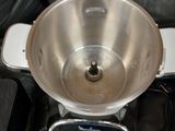 a silver bowl sitting on top of a silver mixer
