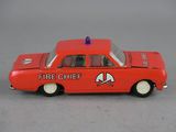 a red toy car with a fire chief on top of it