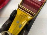 three toy cars that are sitting on a table