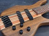 a close up of a bass guitar on a black surface
