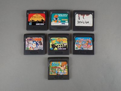 six video game cartridges sitting on top of a table