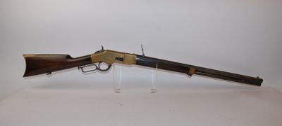 a rifle with a wooden barrel on a clear stand