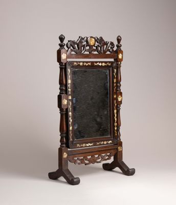a mirror that is on a stand with a mirror on it