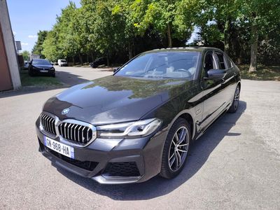 bmw m90 xdrive in a parking lot with trees in the background