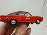 a person holding a toy car in their hand