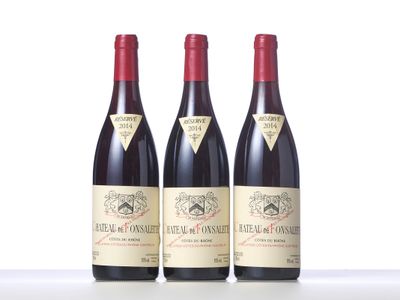 three bottles of red wine sitting on top of a white table