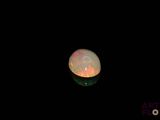 an image of a white fire opal in the dark